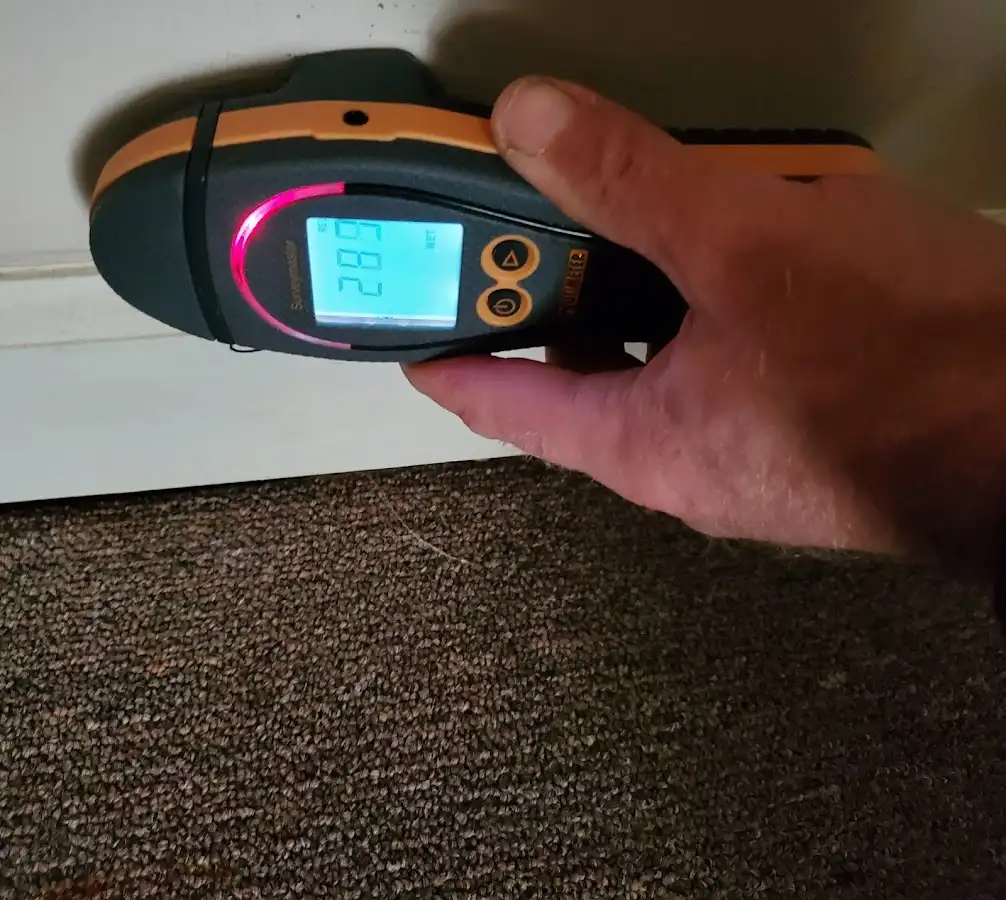 Moisture detection at baseboard during Storm Damage Restoration in Laketon